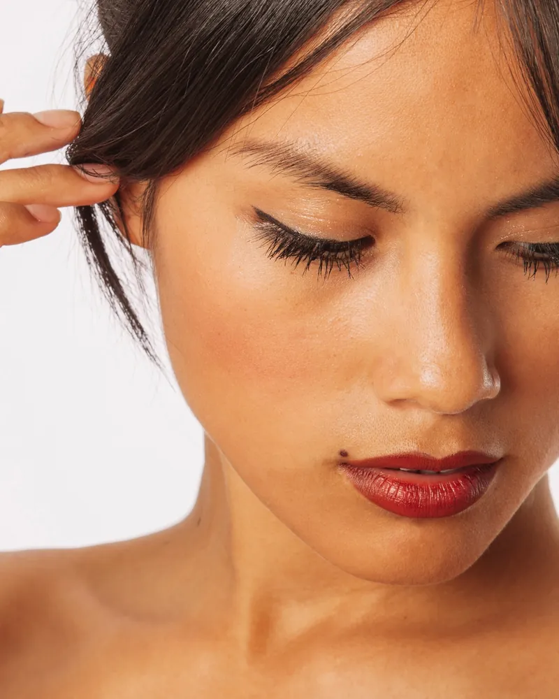 Portrait of a woman with defined natural lashes, looking down